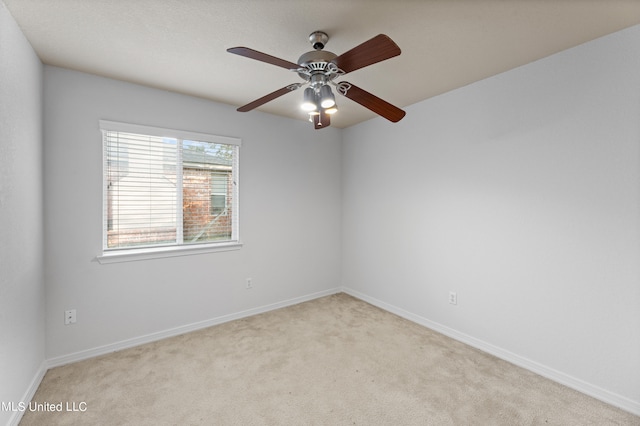 spare room with light carpet and ceiling fan