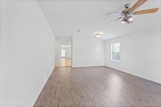 unfurnished room featuring ceiling fan, hardwood / wood-style flooring, and vaulted ceiling