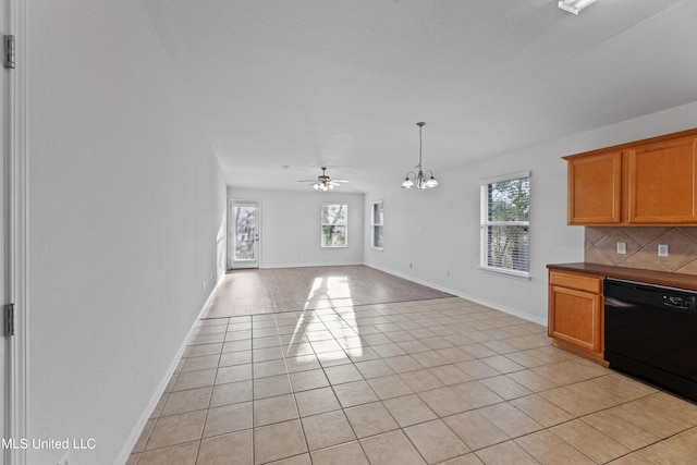 kitchen with backsplash, black dishwasher, a healthy amount of sunlight, and light tile patterned floors