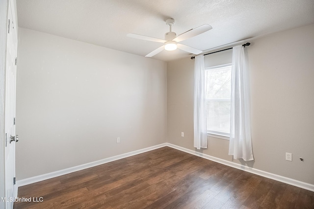 spare room with ceiling fan, dark hardwood / wood-style floors, and a wealth of natural light