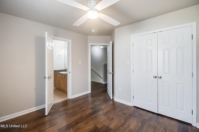 unfurnished bedroom featuring ceiling fan, dark hardwood / wood-style flooring, and a closet