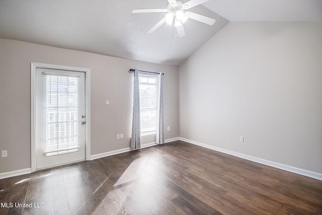 unfurnished room with lofted ceiling, plenty of natural light, and dark hardwood / wood-style floors