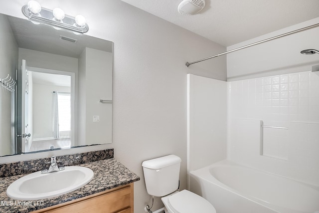 full bathroom featuring vanity, toilet, shower / bath combination, and a textured ceiling