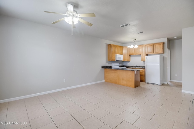 kitchen with light tile patterned flooring, hanging light fixtures, kitchen peninsula, white appliances, and ceiling fan with notable chandelier