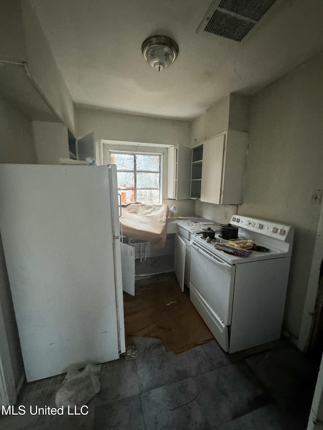 washroom featuring cabinets and washer and clothes dryer