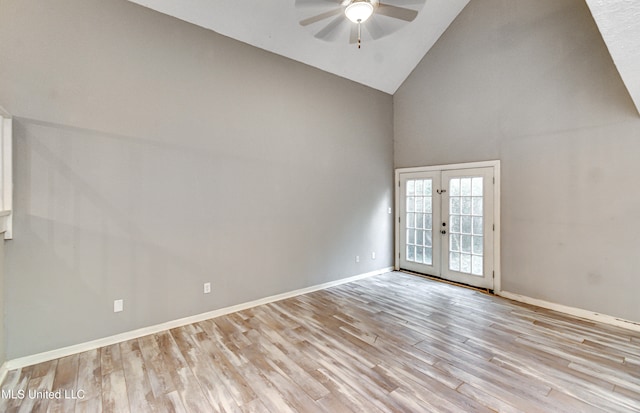 spare room featuring high vaulted ceiling, ceiling fan, french doors, and light hardwood / wood-style floors