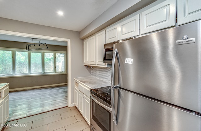 kitchen featuring light wood-type flooring, white cabinets, and stainless steel appliances