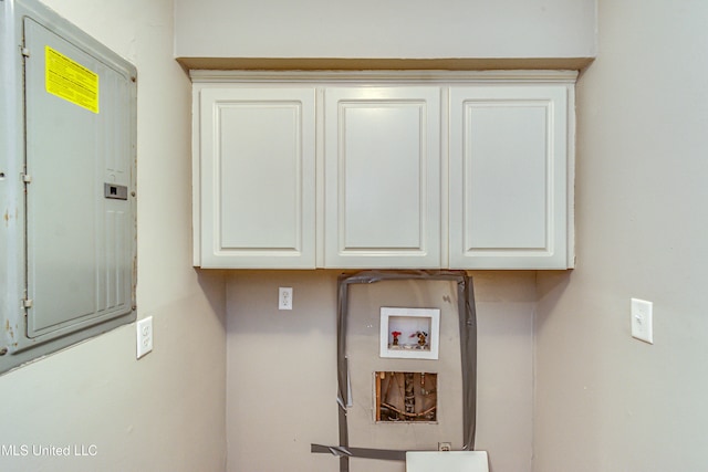 washroom featuring cabinets, electric panel, and hookup for a washing machine