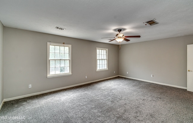 carpeted spare room with a textured ceiling and ceiling fan