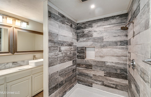 bathroom featuring vanity and a tile shower