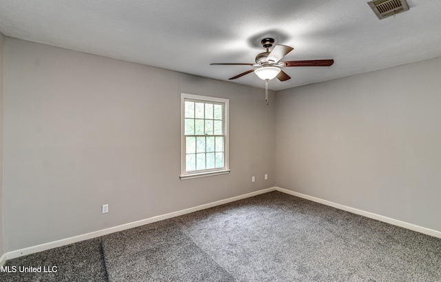 unfurnished room featuring ceiling fan, a textured ceiling, and carpet