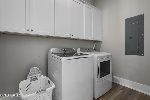 laundry area with cabinet space, electric panel, baseboards, washer and clothes dryer, and dark wood-type flooring