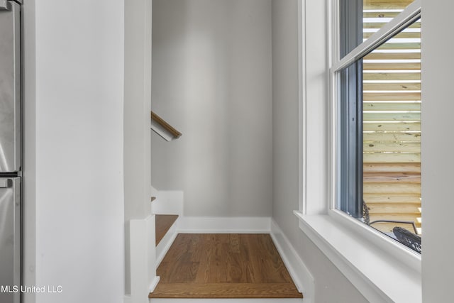 interior space with baseboards and wood finished floors