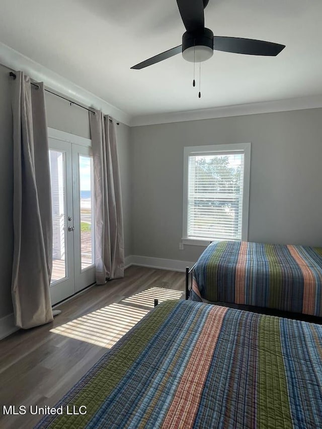 unfurnished bedroom featuring ceiling fan, wood finished floors, access to exterior, crown molding, and french doors