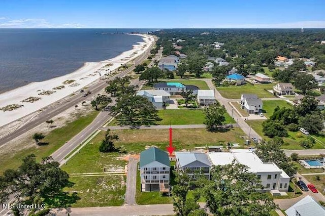 birds eye view of property featuring a beach view and a water view