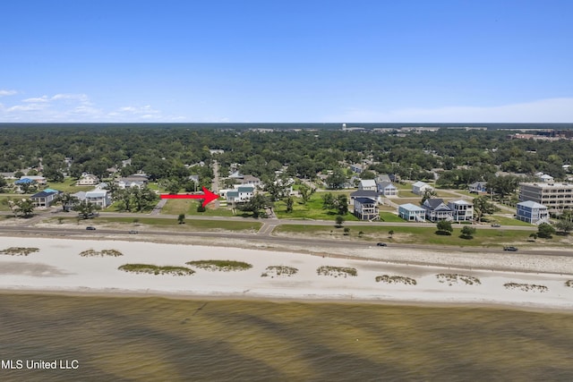 drone / aerial view featuring a water view and a beach view