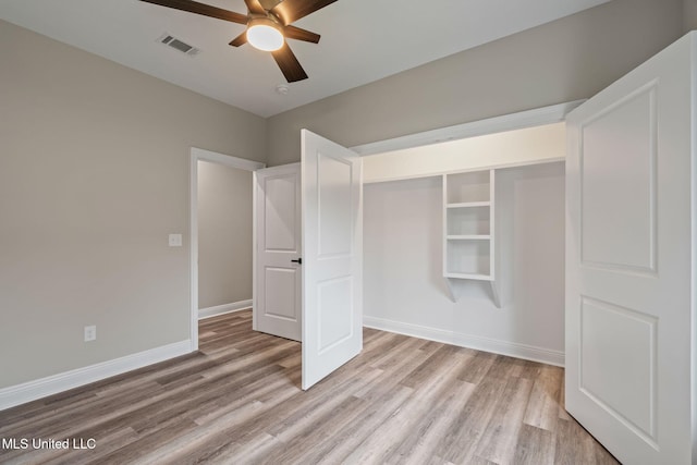 unfurnished bedroom featuring baseboards, visible vents, light wood-style flooring, and a ceiling fan