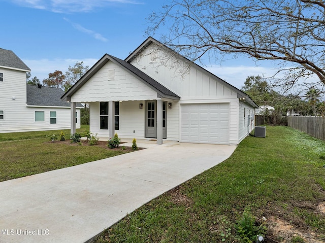 view of front of property featuring concrete driveway, an attached garage, central AC unit, board and batten siding, and a front lawn