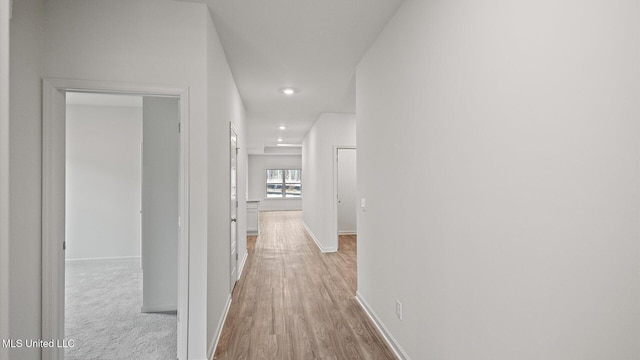 corridor with light hardwood / wood-style floors