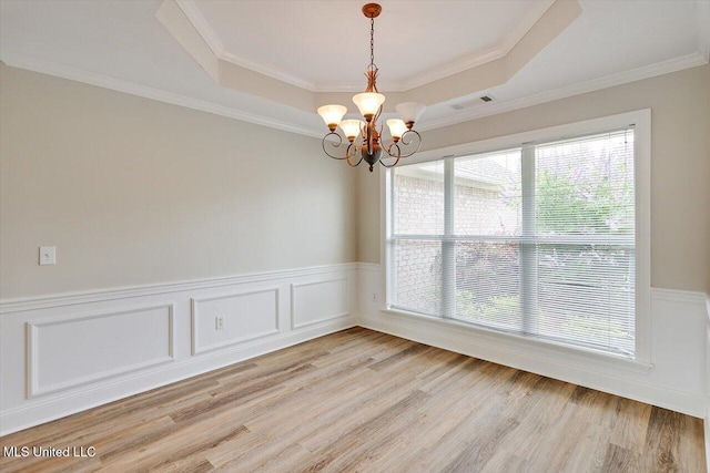 453 Abbey Woods, Brandon, MS 39047 - empty room with a chandelier, a tray ceiling, wainscoting, light wood finished floors, and crown molding