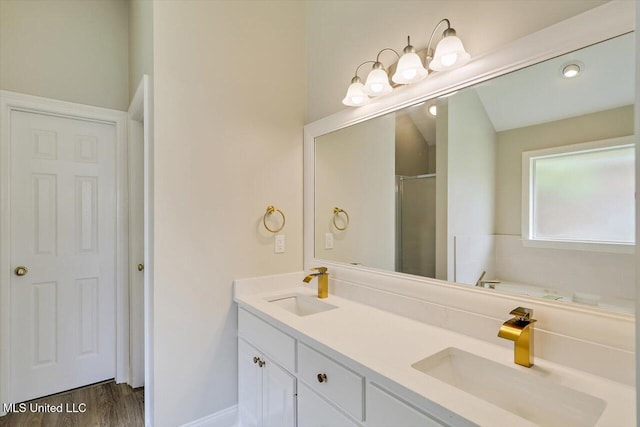 453 Abbey Woods, Brandon, MS 39047 - full bathroom with double vanity, a garden tub, a shower, and wood finished floors