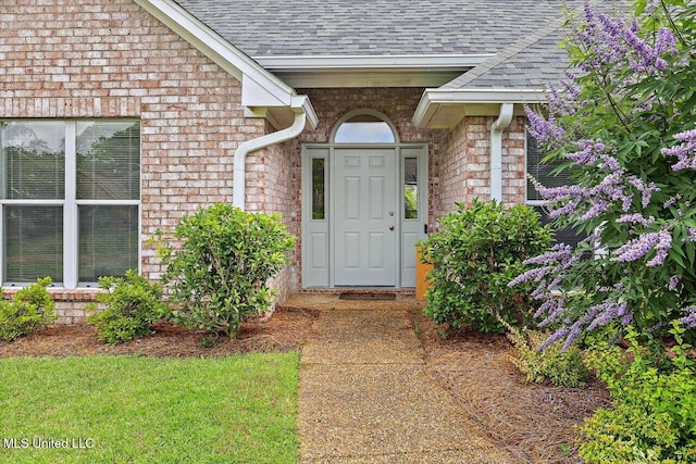 453 Abbey Woods, Brandon, MS 39047 - view of exterior entry with roof with shingles and brick siding