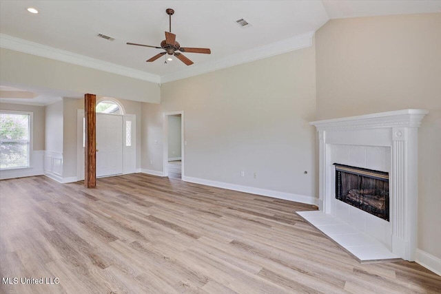 453 Abbey Woods, Brandon, MS 39047 - unfurnished living room with a ceiling fan, light wood finished floors, a tiled fireplace, and crown molding