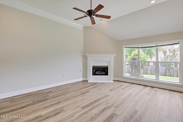 453 Abbey Woods, Brandon, MS 39047 - unfurnished living room featuring ceiling fan, light wood finished floors, lofted ceiling, a tile fireplace, and baseboards