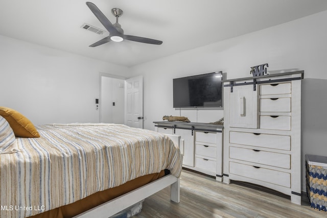 bedroom with hardwood / wood-style floors and ceiling fan