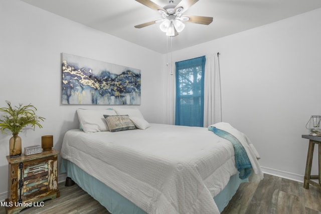 bedroom with ceiling fan and dark wood-type flooring