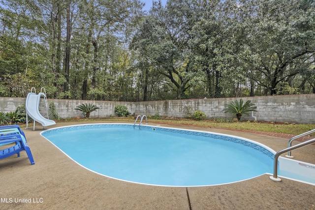 view of pool with a water slide