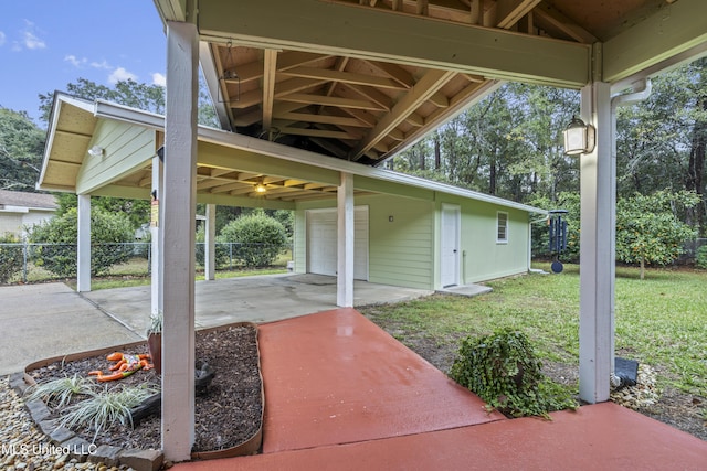 view of patio / terrace featuring a carport and a garage