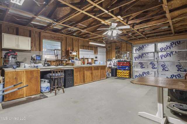 interior space featuring a workshop area and ceiling fan