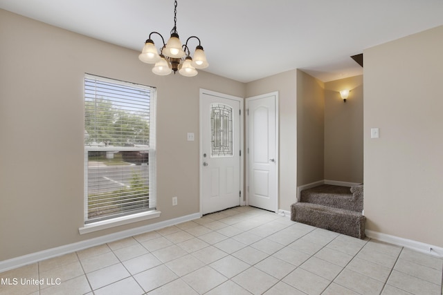 tiled entrance foyer featuring a chandelier