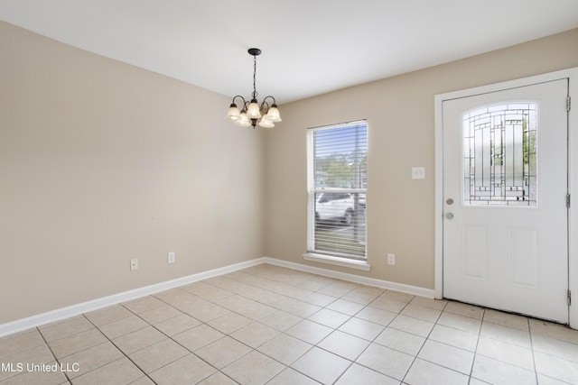 foyer entrance with light tile patterned floors and a chandelier