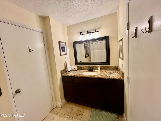 bathroom with vanity and a textured ceiling