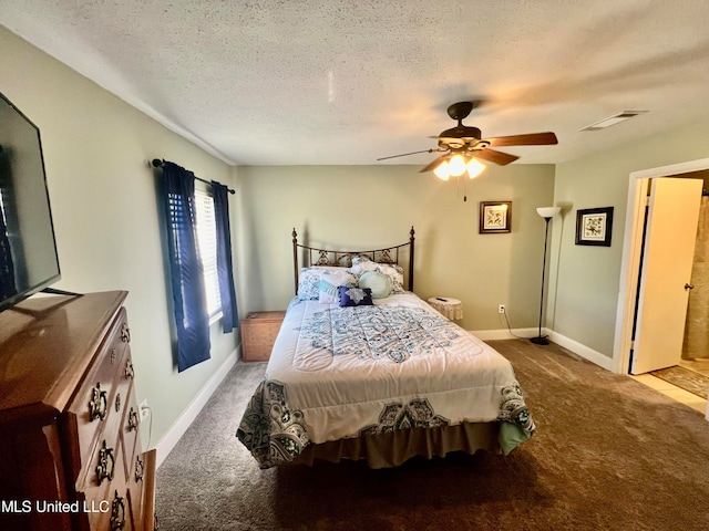 bedroom featuring a textured ceiling, carpet, and ceiling fan