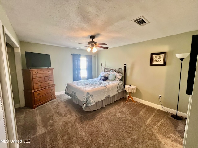 carpeted bedroom with a textured ceiling and ceiling fan