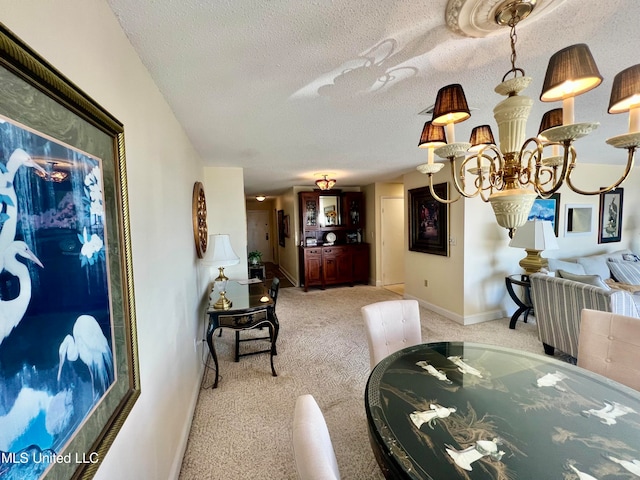 carpeted dining room featuring a textured ceiling