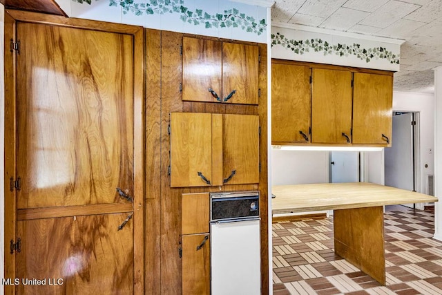 20332 Red Bird Hill Rd, Gulfport, MS 39503 - kitchen with brown cabinets and brick patterned floors