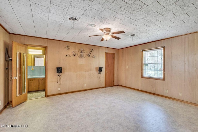 20332 Red Bird Hill Rd, Gulfport, MS 39503 - spare room with ceiling fan, wooden walls, crown molding, and baseboards
