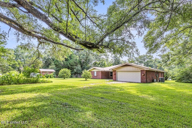 20332 Red Bird Hill Rd, Gulfport, MS 39503 - view of green lawn with an attached garage and cooling unit