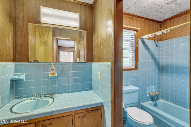 20332 Red Bird Hill Rd, Gulfport, MS 39503 - full bathroom featuring shower / washtub combination, toilet, vanity, tile walls, and ornamental molding