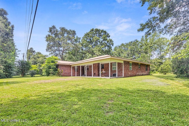 20332 Red Bird Hill Rd, Gulfport, MS 39503 - back of house featuring brick siding, a lawn, and a patio