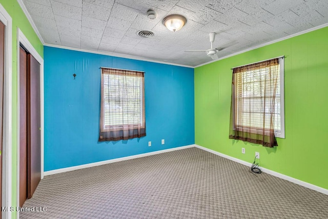 20332 Red Bird Hill Rd, Gulfport, MS 39503 - spare room featuring ornamental molding, carpet floors, a ceiling fan, and a smoke detector