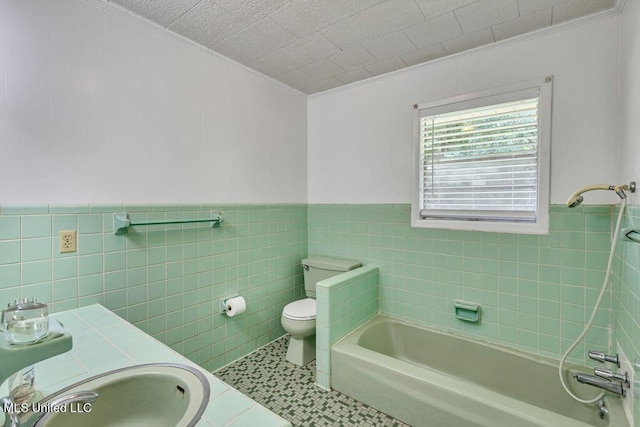 20332 Red Bird Hill Rd, Gulfport, MS 39503 - bathroom with ornamental molding, tile walls, a tub, a sink, and toilet