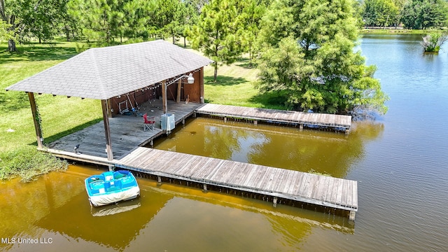 dock area with a yard and a water view