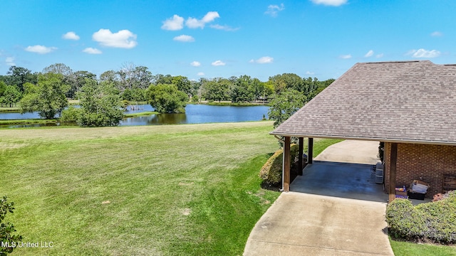 view of yard with a water view and a carport