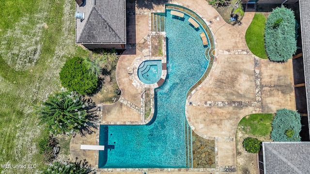 view of swimming pool featuring a patio area and an in ground hot tub