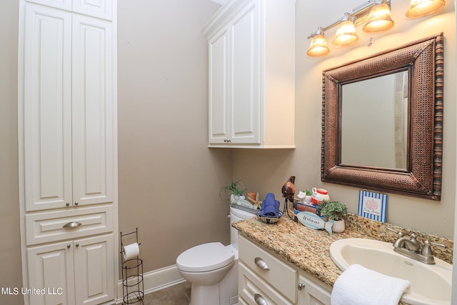 bathroom featuring toilet, vanity, and tile patterned floors